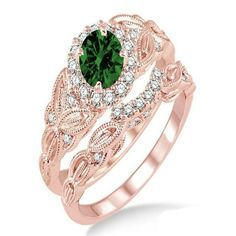 a rose gold engagement ring set with green and white diamonds on the band, featuring an oval