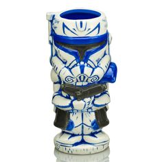 a blue and white ceramic figurine with a helmet on