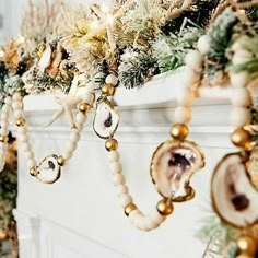 a christmas tree with ornaments hanging from it's branches in front of a fireplace