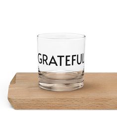 a glass with the words grateful on it