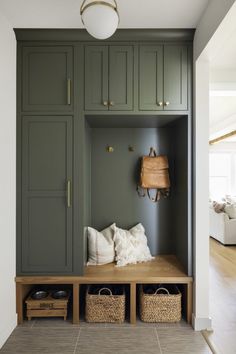 Olive Green Mudroom Cabinets, Mudroom Locker Colors, Mud Room Living Room Combo, Green Lockers Mudroom, Green Garage Cabinets, Green Cabinet Laundry Room, Dark Green Mudroom, Green Mudroom Cabinets, Mud Room Paint Colors