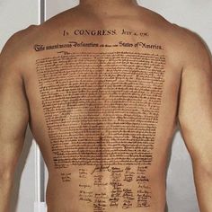 the back of a man's upper body with writing on it and in congress