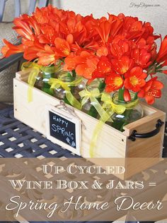 an upcycled wine box and jars filled with red flowers for spring home decor