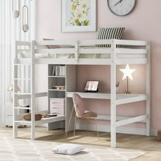 a white loft bed with desk underneath and stairs to the top, next to a pink wall