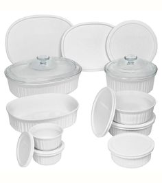 a set of white dishes with lids and plates on the top one has a glass lid