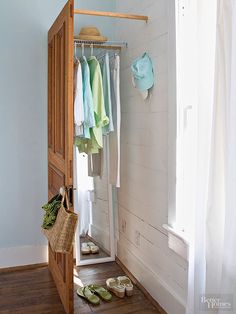 an image of a closet with clothes hanging on it