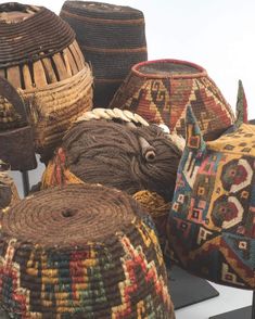 several baskets are stacked on top of each other in different colors and sizes, including one with an elephant's head