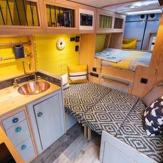 the interior of a camper with yellow walls