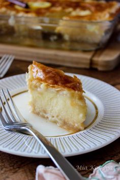 a piece of pie sitting on top of a white plate next to a knife and fork