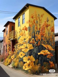 a mural on the side of a building with yellow flowers painted on it's sides