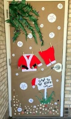 a door decorated with christmas decorations and santa's clothes