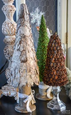 three wooden christmas trees sitting on top of a table