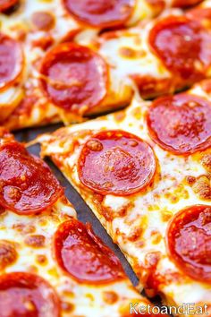 pepperoni pizza cut into slices on a table