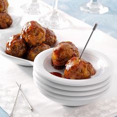 three plates with meatballs on them and two forks in the bowl next to each other