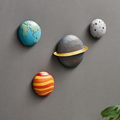 three different colored balls on a gray surface