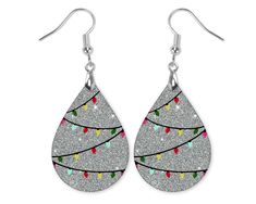 "Christmas Lights Teardrop Dangle MDF Hardboard Earrings -Earrings are made of hardboard with a glossy surface. No actual glitter is used in this pair. It is a glitter design printed on the glossy surface. The design is on both sides of the earrings. -The large teardrops are 1.5\" long, 1\" wide and 1/8\" thick and hang 2.25\" from the top of the earwires. The mini teardrops are 1\" long and .75\" wide and hang 1.25\" from the top of the earwires. -Hardware as shown - these come with stainless steel silver-colored earwires. -Includes fishhook earwires with rubber earring stoppers." Painted Christmas Earrings, Wooden Christmas Earrings, Christmas Earrings Diy, Beginner Jewelry Making, Diy Christmas Earrings, Sublimation Earring Designs, Making Jewelry For Beginners, Winter Earrings