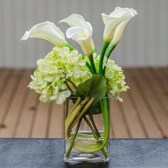 there is a vase with flowers in it on the table