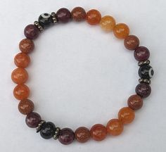 Elevate your jewelry game with this stunning Vibrant Red and Orange gemstone beaded bracelet! 😍🔥 Perfect for any occasion like Christmas🎄, Halloween👻, Birthdays🎂, and Anniversaries🎉, this stackable bracelet is customizable and handmade with love. 💕 Get ready to stand out with this unique piece featuring goldstone and garnet stones. 🙌 #BeadedBracelet #GemstoneJewelry #Handmade #Customizable #Unique #Stackable #Accessorize #Fashion #Style #JewelryAddict Orange Stretch Bracelet With 8mm Beads, Amber Stretch Bracelet With 8mm Beads As Gift, Amber Stretch Bracelet With 8mm Beads For Gift, Amber Hand-strung Stretch Bracelet With Round Beads, Homemade Jewerly, Halloween Beaded Jewelry, Halloween Birthdays, Beaded Work, Autumn Bracelet