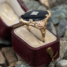 This beautiful vintage onyx ring is crafted of 14k yellow gold and features a diamond accent in white gold. Both shoulders are accented with a rose gold floral motif plaque and the ring is currently a size 5.5. The onyx shows a bit of wear from over the years. Vintage Onyx Ring, Onyx Ring, Gold Floral, A Rose, Floral Motif, Onyx, White Gold, Yellow Gold, Rose Gold