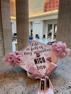 a graduation cap with pink flowers on it and the words, life is full of tiny miracles