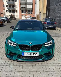 a blue car is parked on the street