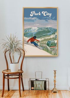 a poster hangs on the wall above a chair and table in a room with wood floors