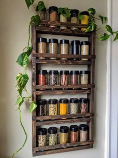 an old wooden spice rack with spices and herbs