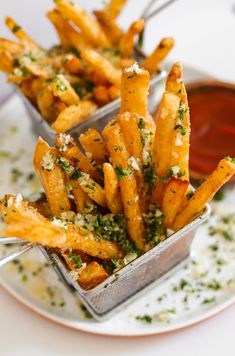 french fries with parmesan cheese and seasoning on a plate