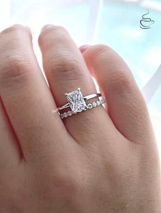 a woman's hand with a diamond ring on it