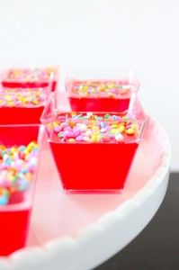 small red cups filled with sprinkles on a plate