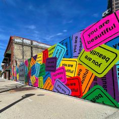 colorful street signs painted on the side of a building