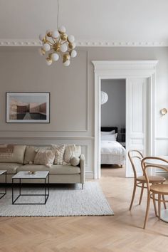 a living room filled with furniture and a chandelier