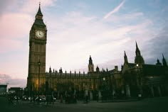 the big ben clock tower towering over the city of london, england at sunset or dawn