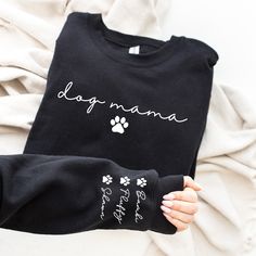 a person wearing a dog mama shirt with paw prints on their sleeves and the words dogs mama written in cursive writing