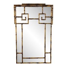 a mirror that is sitting on top of a table with a gold frame around it