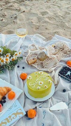 there is a cake and other food on the beach