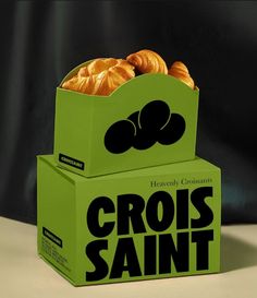 two boxes with croissants stacked on top of each other