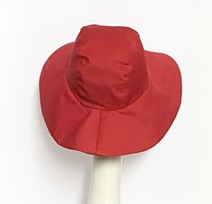 Wide Brim sun hat made with red cotton twill , lined in rayon print, the hat has a 2 section crown 3 1/2 " in length and a one piece 4" brim, a cotton band inside. One size fits most up to 23" Machine wash cold / hand dry Made in USA Press if needed / packable Fitted Sun Hat With Upf 50+ And Curved Brim, Fitted Sun Hat With Upf 50+, Red Curved Brim Hat For Summer, Red Curved Brim Summer Hat, Red Bucket Sun Hat For Spring, Red Brimmed Bucket Hat For Summer, Red Bucket Hat For Spring, Lined Brimmed Hat, One Size Fits Most, Wide Brim Red Bucket Hat For Summer