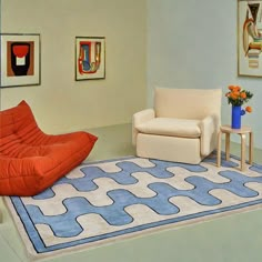 an orange chair sitting on top of a blue rug