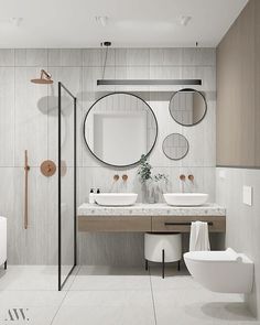 a modern bathroom with two sinks and mirrors