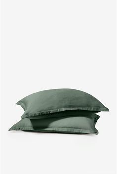 two green pillows sitting on top of each other