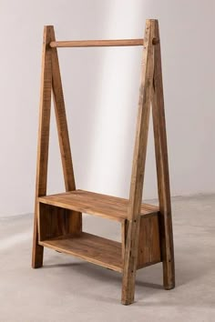 a wooden shelf sitting on top of a cement floor