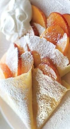 some desserts are on a white plate with powdered sugar