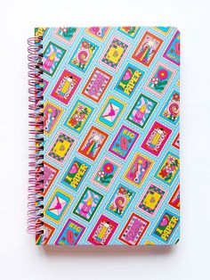 a spiral notebook with colorful designs on it