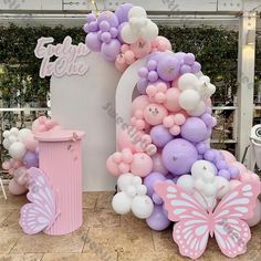 balloons and decorations are arranged in the shape of a butterfly for a baby's first birthday party