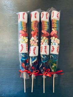 four candy sticks with baseball designs on them