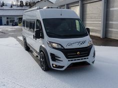 a white van is parked in the snow