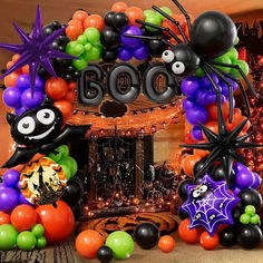 balloons and decorations decorate the entrance to a home decorated for halloween with bats, spider webs and pumpkins