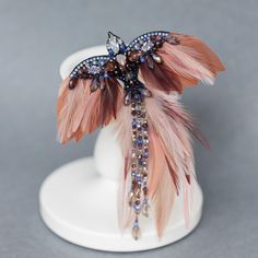 a close up of a feather brooch on a mannequin headdress