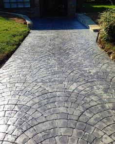 a brick walkway in front of a house